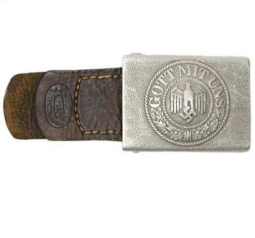 This is a very uncommon buckle which is (if you find it) always unmarked and only maker marked on the leather tab.