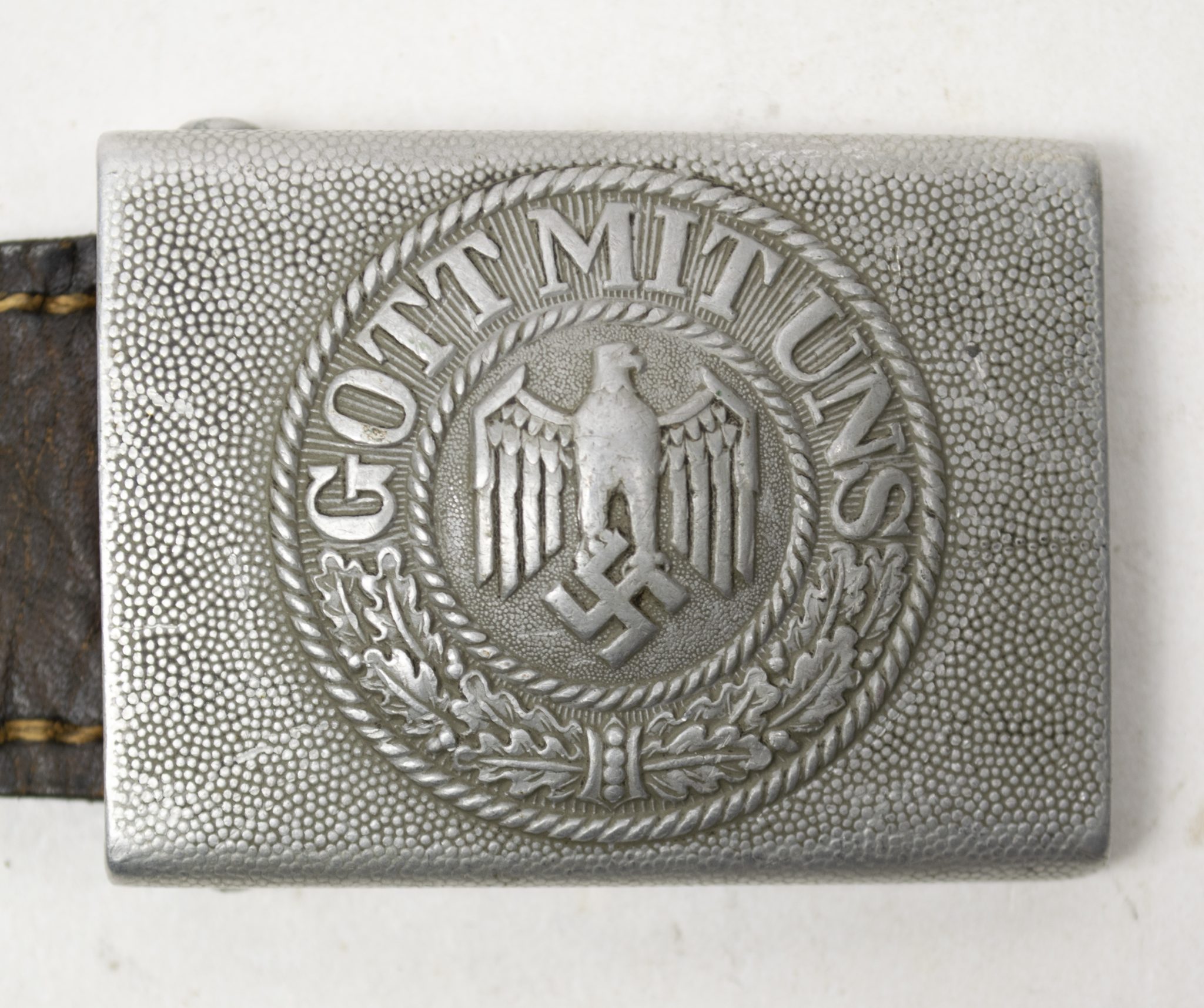 This is a very uncommon buckle which is (if you find it) always unmarked and only maker marked on the leather tab. (8)